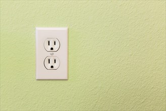 Electrical sockets in colorful wall of house