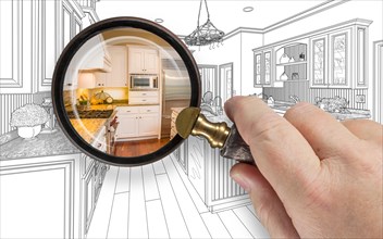 Hand holding magnifying glass revealing custom kitchen design drawing and photo combination