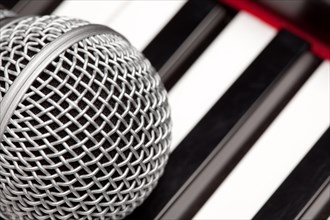 Microphone laying on electronic keyboard with narrow depth of field