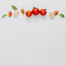 whole slice cherry tomatoes garlic clove basil white background