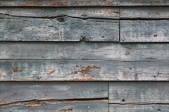 Weathered wood panel wall with peeling paint textured background
