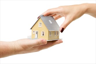 Female hand reaching for a house isolated on a white background