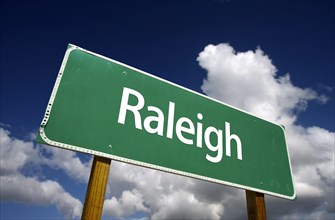 Raleigh road sign with dramatic blue sky and clouds