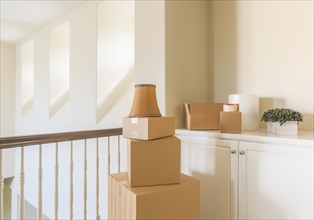 Variety of packed moving boxes and materials in empty room