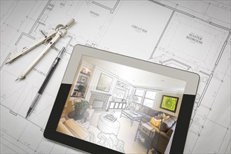Computer tablet showing living room illustration sitting on house plans with pencil and compass