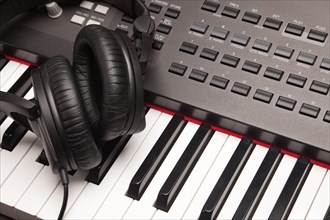Headphones laying on electronic keyboard with narrow depth of fiel