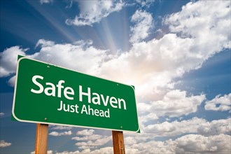 Safe haven green road sign with dramatic clouds