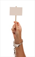 Handcuffed woman holding blank white sign isolated on a white background