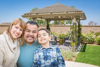 mixed-race family in back yard near patio cover