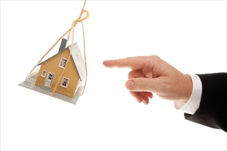 Swinging house and business man's hand reaching or pushing isolated on a white background