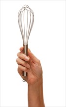Woman holding egg beater in the air isolated on a white background
