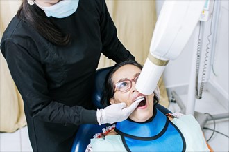 Female dentist doing dental x-ray
