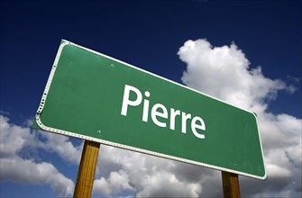 Pierre road sign with dramatic blue sky and clouds