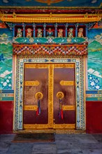 Door gate in Buddhist monastery. Mud village