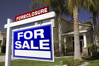 Foreclosure for sale real estate sign in front of house