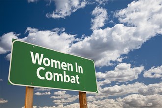 Women in combat green road sign over clouds and sky