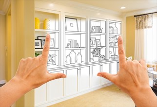 Hands framing custom built-in shelves and cabinets design drawing with section of finished photo