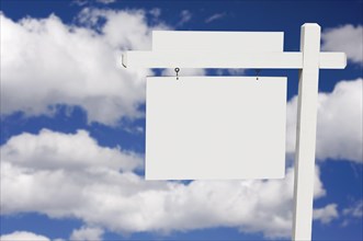 Blank real estate sign on clouds & sky background