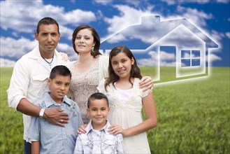 Happy hispanic family standing in grass field with ghosted house behind