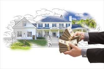 Hand holding thousands of dollars in cash over house drawing and photo area
