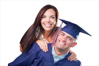 Proud male graduate in cap and gown with pretty girl isolated on white