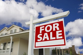 Home for sale sign in front of new house