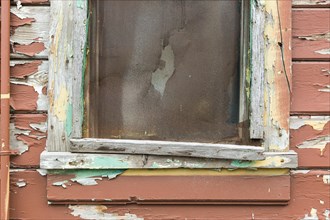 Weathered wood panel wall and window with peeling paint textured background