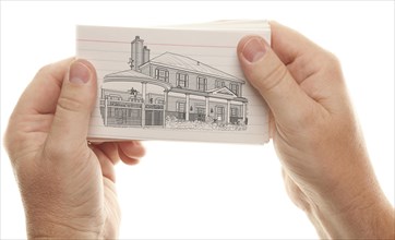 Male hand holding stack of flash cards with house drawing isolated on a white background