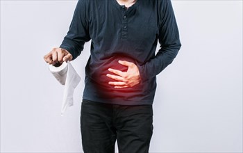 Person with toilet paper with stomach problems on isolated background