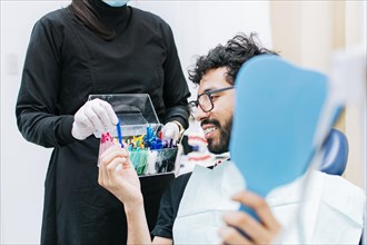Patient with dentist choosing dental braces