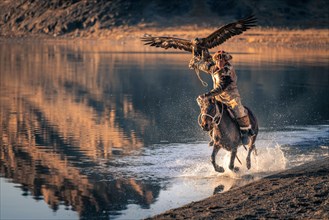 Young Eagle Hunter Riding on Tolbo Lake in Western Mongolia