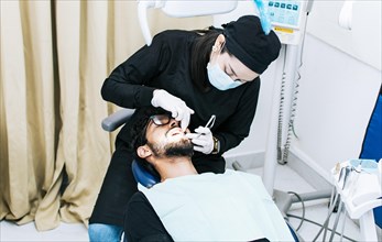 Dentist performing dental checkup