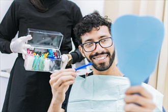 Dentist with patient choosing metal braces