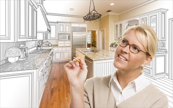 Creative woman with pencil over custom kitchen design drawing and photo combination