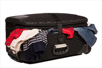 Overstuffed baggage in old suitcase isolated on white background