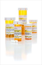 Non-Proprietary medicine prescription bottles and pills isolated on a white background