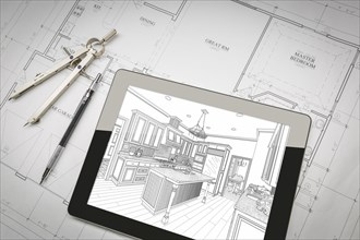 Computer tablet showing kitchen illustration sitting on house plans with pencil and compass