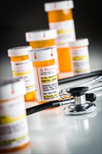 Several non-proprietary medicine prescription bottles abstract with stethoscope