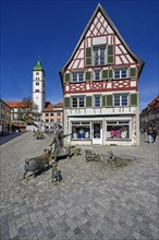 Tower of St. Martin's Church and half-timbered house with St. Anthony's Fountain by Werner Guertner in the historic old town