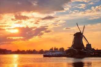 Windmills at famous tourist site Zaanse Schans in Holland on sunset with dramatic sky Zaandam