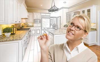Creative woman with pencil over custom kitchen design drawing and photo combination