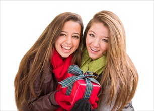 mixed-race young adult females holding A christmas gift isolated on a white background