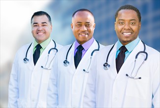 Handsome african american and hispanic male doctors outside of hospital building