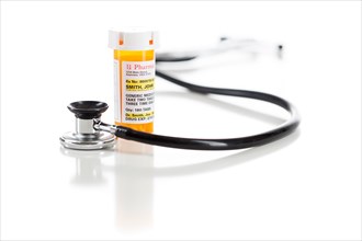 One non-proprietary medicine prescription bottle with stethoscope isolated on a white background