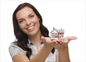 mixed-race woman holding small house isolated on white background