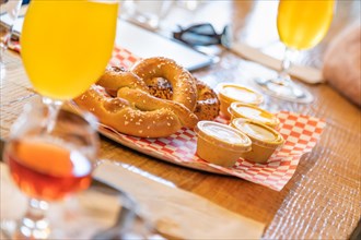 Abstract of small glass of micro brew beers and warm pretzels on bar