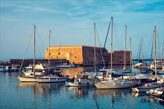 Venetian Fort castle in Heraklion and moored fishing boats