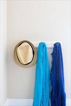 Wall in house with hat and scarfs hanging on coat rack hooks abstract