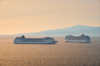 Cruise ships in Aegean sea on sunset. Mykonos island