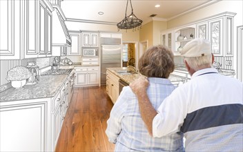 Senior couple looking over custom kitchen design drawing and photo combination